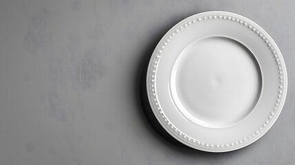12. A minimalist image with a white background showcasing a plain white plate, centered and empty
