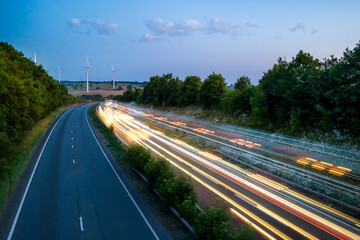 heavy one way traffic moving at speed on UK motorway in England at sunset