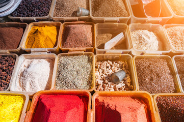 assortment of various oriental spices on the counter at bazaar in Uzbekistan