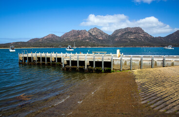 Coles Bay jetty and boat ramp with the Freycinet National Park in the background. 