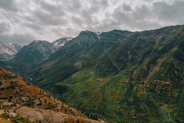Fototapeta premium The mountains are covered in green vegetation and the sky is cloudy