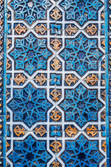 ancient ceramic tile with a traditional Arabic pattern Uzbek ornament decorates the wall of the old islamic Hazrati Imam mosque in Tashkent in Uzbekistan