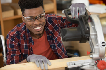 happy carpenter doing woodwork in carpentry