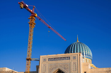 The Center of Islamic Civilization in Tashkent in Uzbekistan. Crane on a construction site builds a...