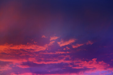 Beautiful sunset sky above clouds with dramatic light. Cabin view from airplane