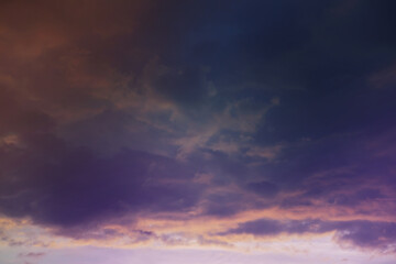 Beautiful sunset sky above clouds with dramatic light. Cabin view from airplane