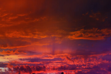 Beautiful sunset sky above clouds with dramatic light. Cabin view from airplane