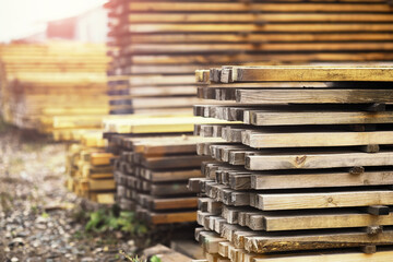 Stack of fresh pine boards in a sawmill warehouse. Harvesting, sale of lumber for construction