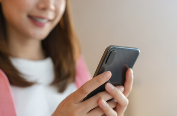 Woman using smartphone in public areas, During leisure time. The concept of using the phone is essential in everyday life.
