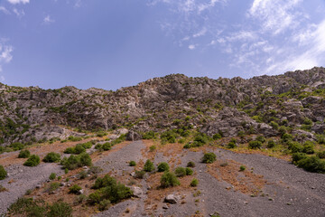 A rocky mountain with a clear blue sky