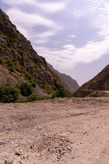 A mountain range with a dirt road in between