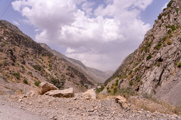 A rocky mountain valley with a cloudy sky