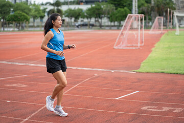 Obraz premium Asia mature woman Runner drill training on race track and field