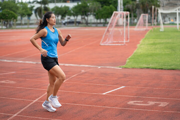 Fototapeta premium Asia mature woman Runner drill training on race track and field