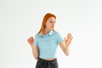 Young caucasian woman looking at manicure on white background