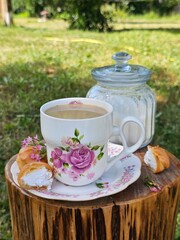 Coffee with milk and profiteroles on a wooden background