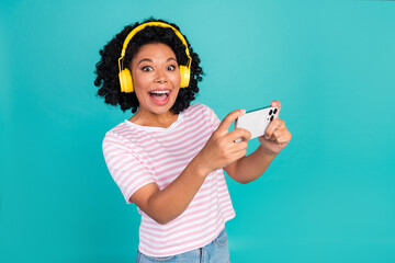 Photo of funny youngster girl with curly hairstyle listen music her wireless earphones gamer hold...