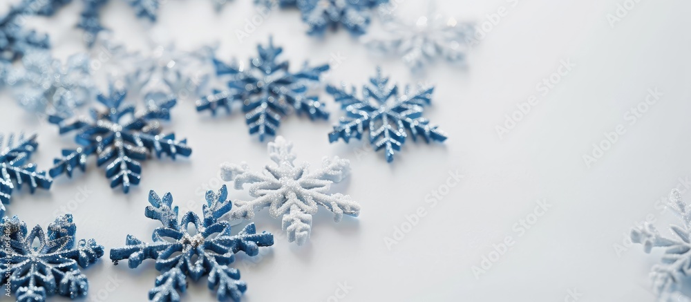 Aufkleber Decorative snowflakes on a white backdrop with room for a message in a copy space image.