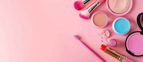 Naklejka premium Colorful cosmetics set on a pink background with copy space image.