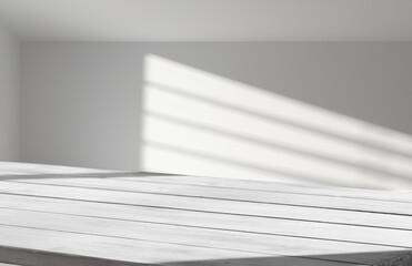 An elegant and subtle abstract light backdrop for product display with graceful and subtle shadows cast by tree branches on the wall. rays of the window, with an empty table