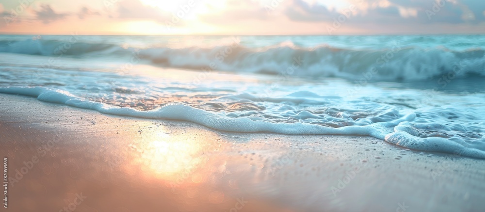 Aufkleber Blurry image of gentle waves on sandy beach at dusk with soft focus and empty copy space.