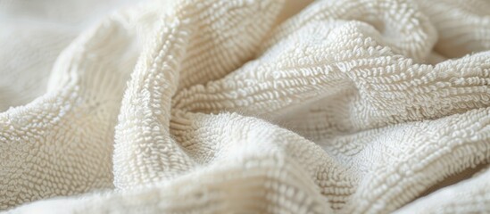 Close-up image of a white terry cloth towel showcasing its fabric texture, with a focus on macro details and ample copy space.