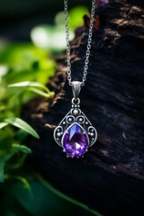 A necklace featuring a regal amethyst stone hanging from a sterling silver chain, adding a touch of elegance and sophistication to any outfit