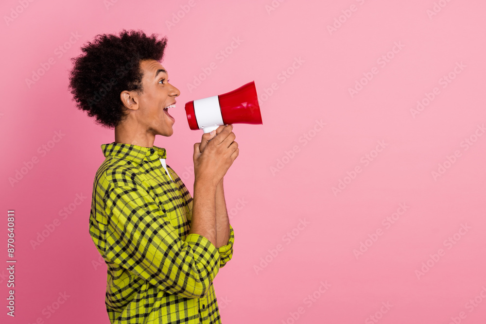 Poster Photo of nice young man loudspeaker empty space wear shirt isolated on pink color background