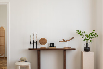 Stylish and minimalist composition on wooden design commode with copy space, flowers in vase, decorations and personal accessories. Template.