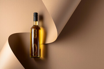 Bottle of white wine on a beige background.