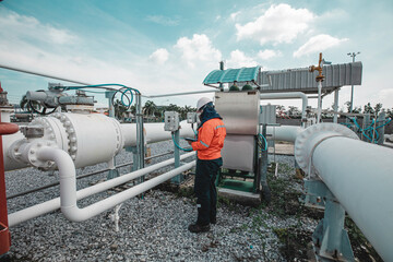 Male worker inspection at steel long pipes and pipe elbow in station oil factory during refinery...