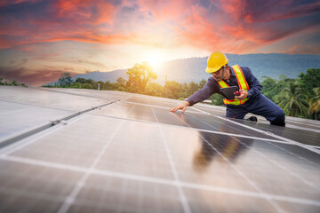 An engineer on roof meticulously inspects solar cell panels using a tablet and communicates...