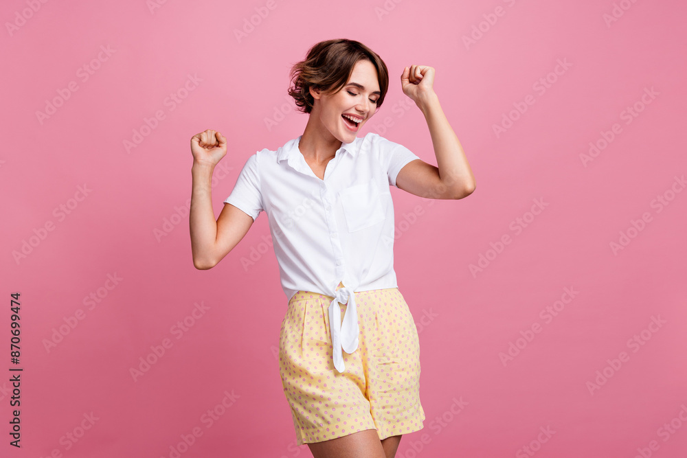 Sticker portrait of satisfied gorgeous girl with short hairstyle wear stylish blouse clenching fists win bet