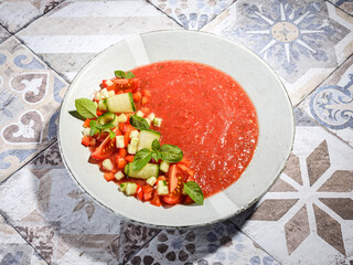 gazpacho food styling on a tile background