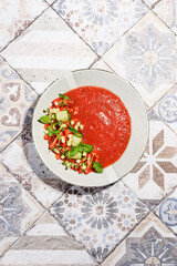 gazpacho food styling on a tile background