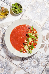 gazpacho food styling on a tile background