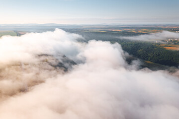 Majestic scene of plain in the fog from a bird's eye view.