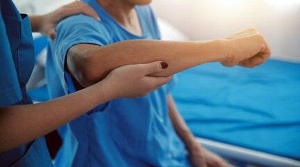 Physiotherapist man giving exercise with dumbbell treatment About Arm and Shoulder of athlete male patient Physical therapy concept