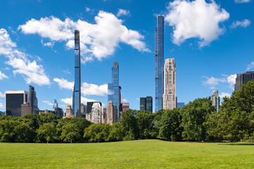 Central Park in summer with Billionaires' Row supertall skyscrapers from Sheep Meadow. Midtown Manhattan, New York City