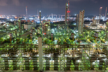 Fototapeta premium Nighttime Aerial View of Busy Refinery Complex