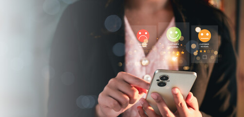 close up hand using smart phone and give five star symbol to increase rating of product and service...