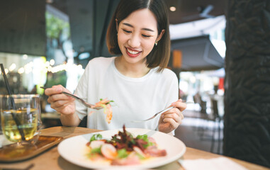 Asian woman eating healthy food at cafe restaurant city break on weekend lifestyle