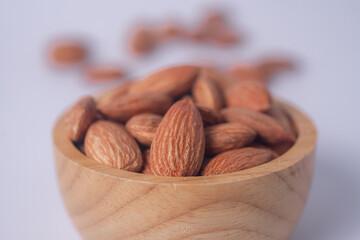 Almond snack fruit in wooden bowl blur white background