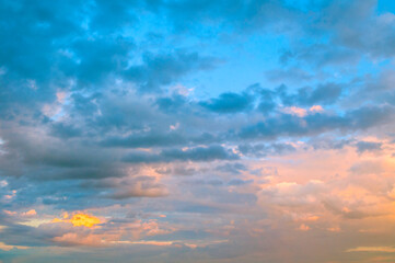 Blue sky background - picturesque colorful clouds lit by sunlight, picturesque sky view