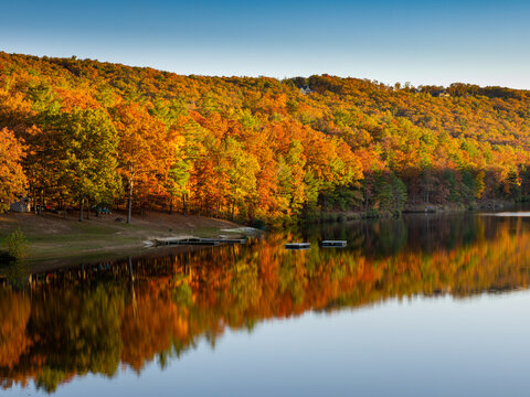 Fall landscape with trees mirrored in lake