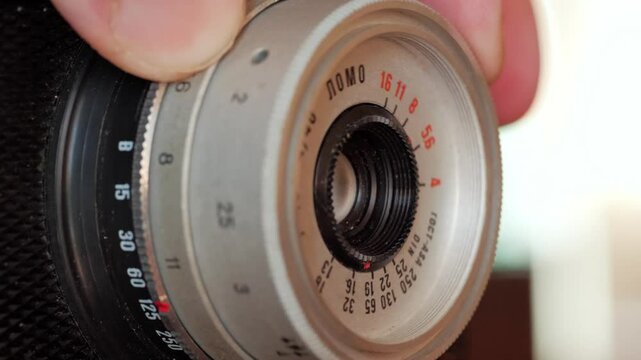 Fingers Delicately Adjust Focus Ring on Vintage Film Camera
