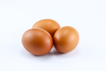 group of three raw asian chicken eggs on white isolated background
