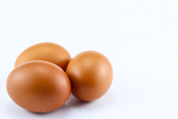 group of three raw asian chicken eggs on white isolated background