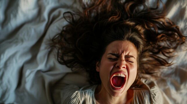 High Angle View Of A Young Woman In Bed Getting Orgasm