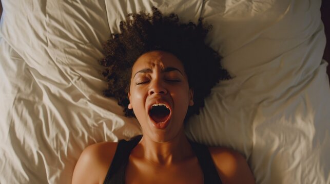 High Angle View Of A Young Woman In Bed Getting Orgasm